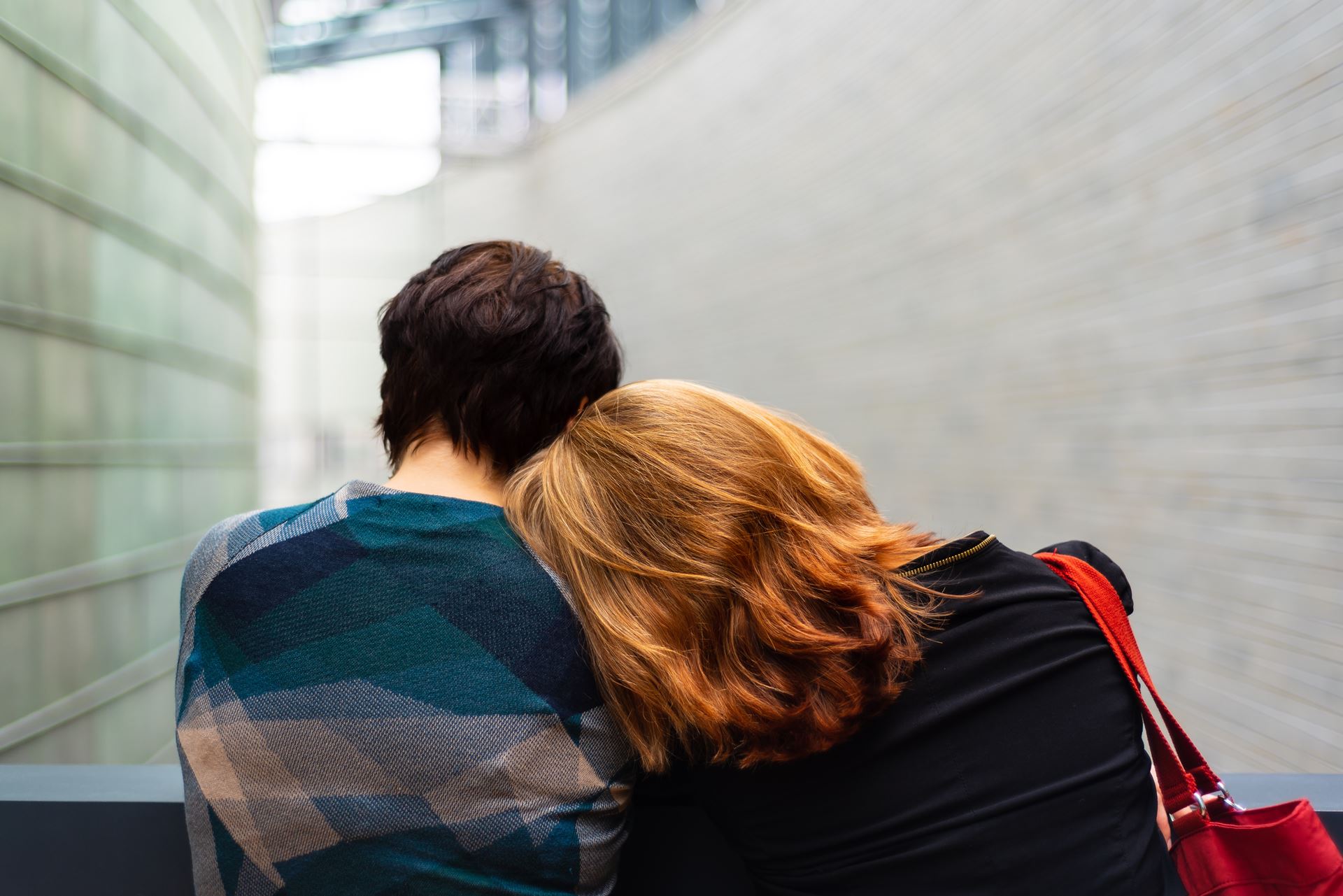 Image of a man with a woman resting her head on his shoulder